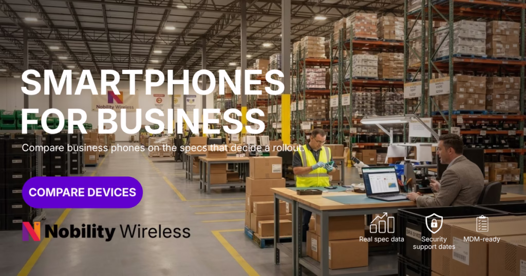 IT procurement manager and warehouse technician reviewing enterprise smartphone device specs on a laptop, surrounded by palletized inventory.
